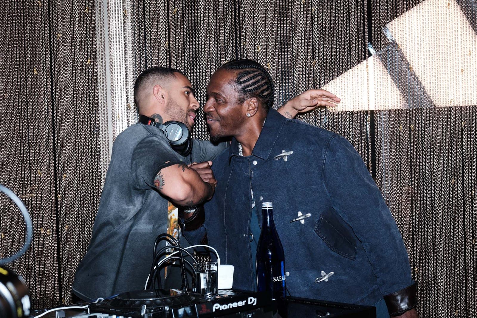 Two of the DJs laughing behind the decks