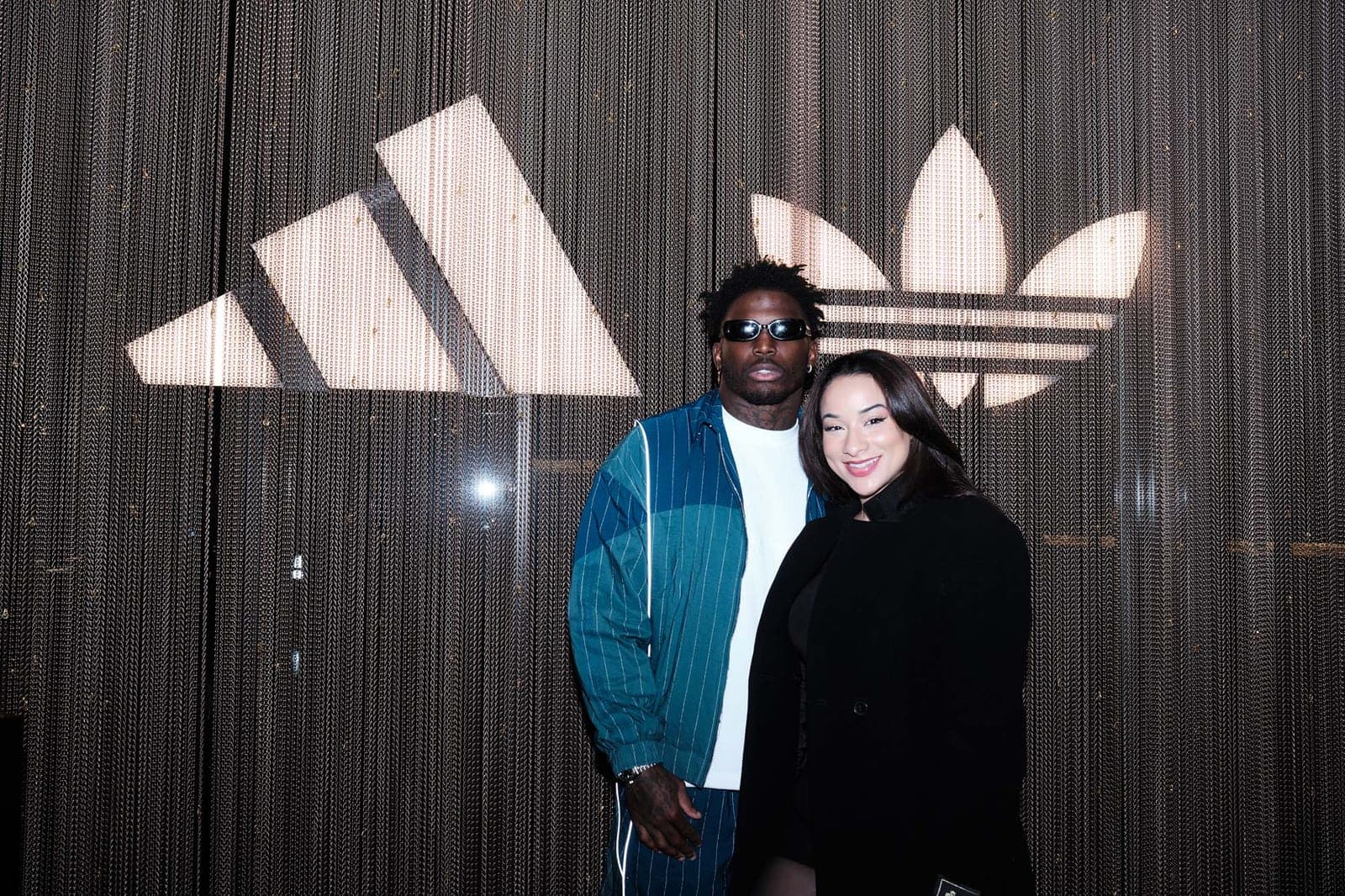 A couple photographed against the chain curtain