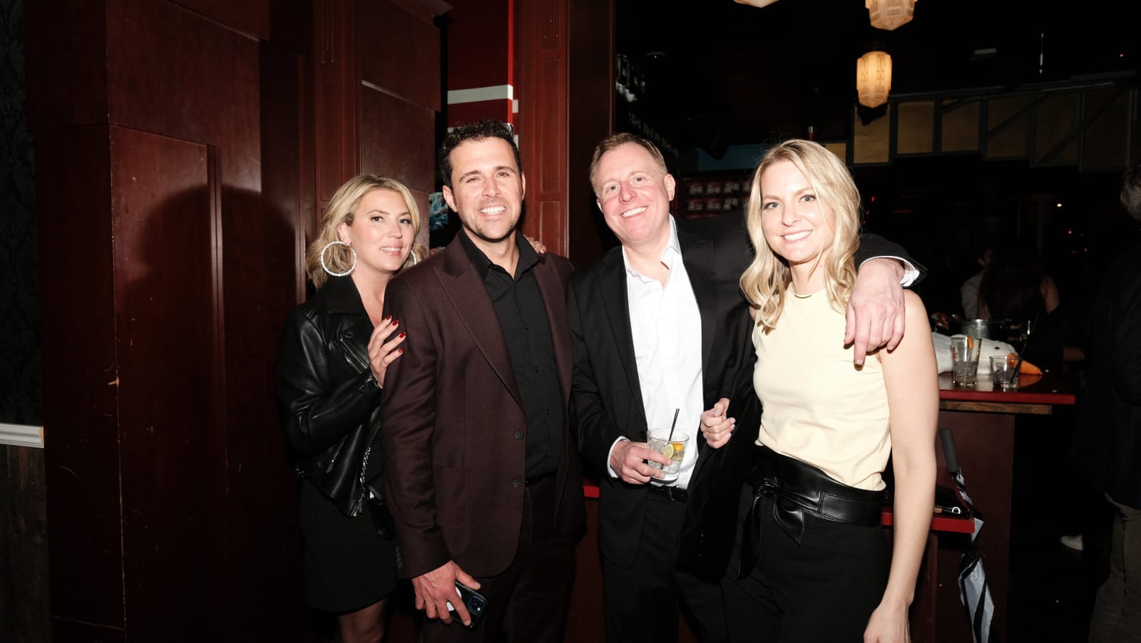 Four guests together at the end of the bar