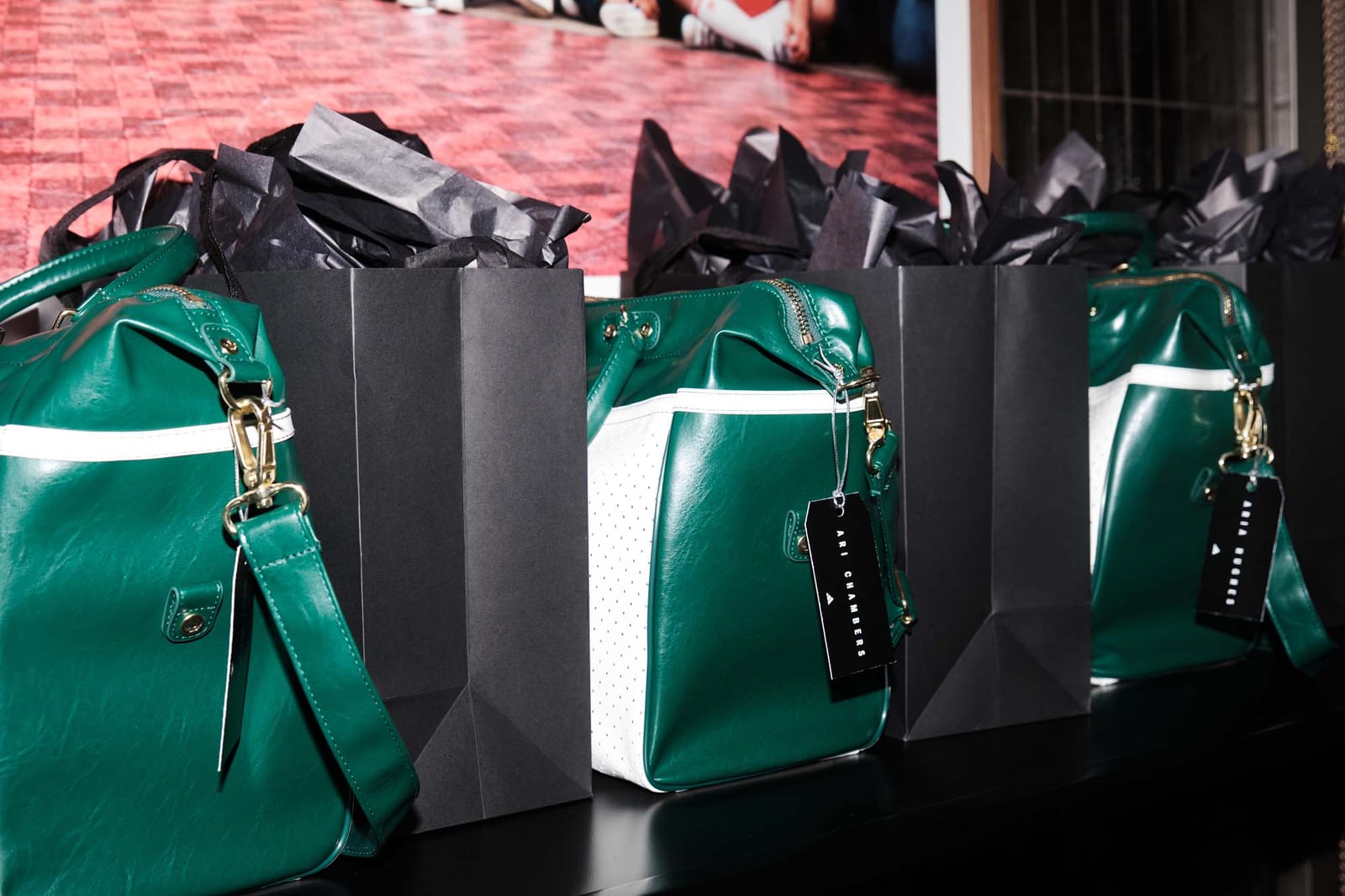 Green leather gift bags lined up on the carpet