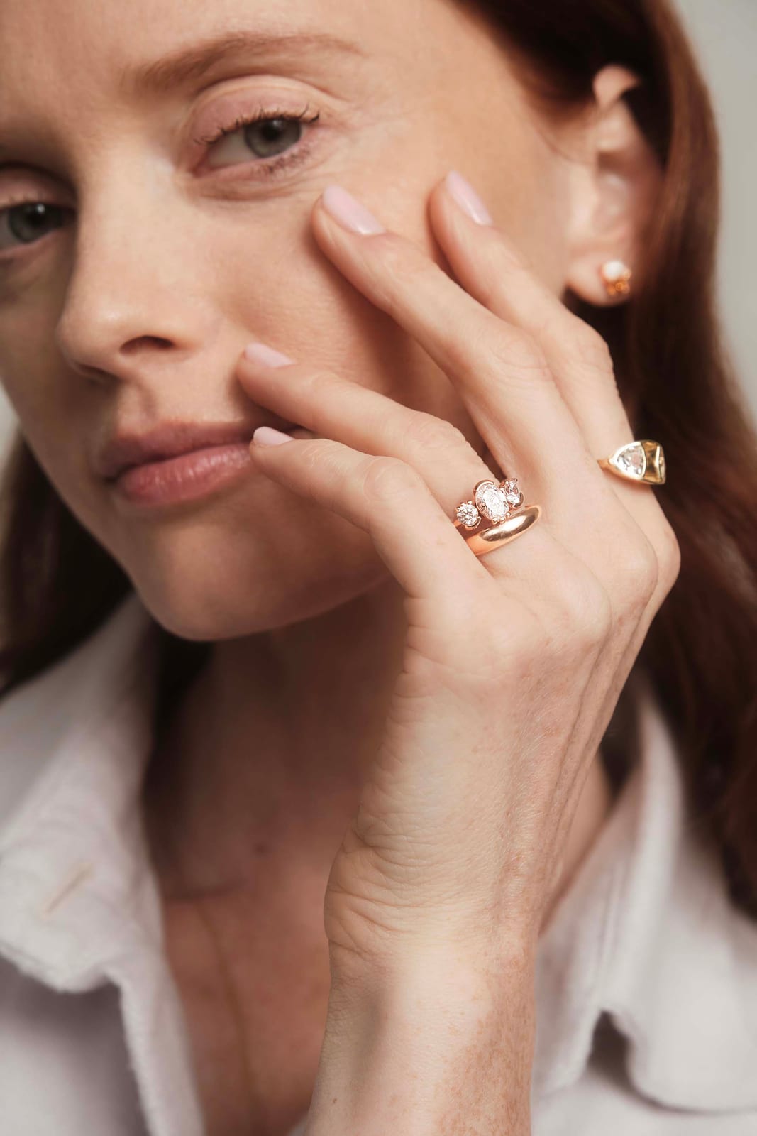 A signet ring against the cheek in daylight