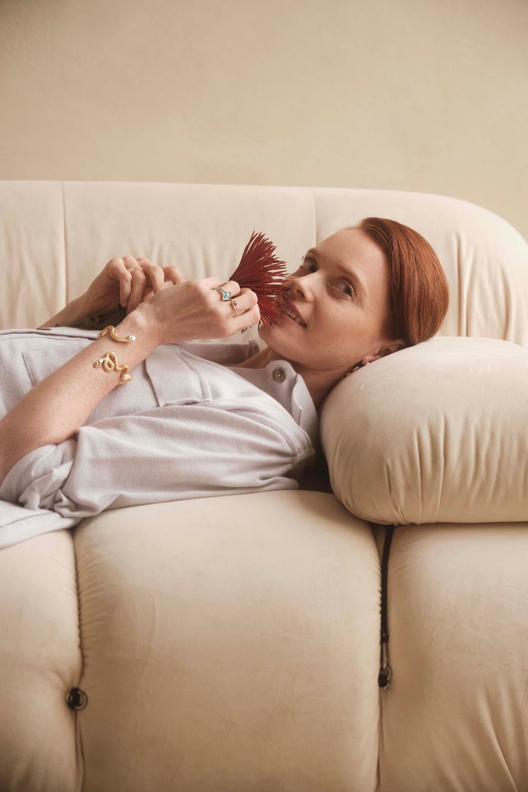 Resting on a cream sofa with a dried flower