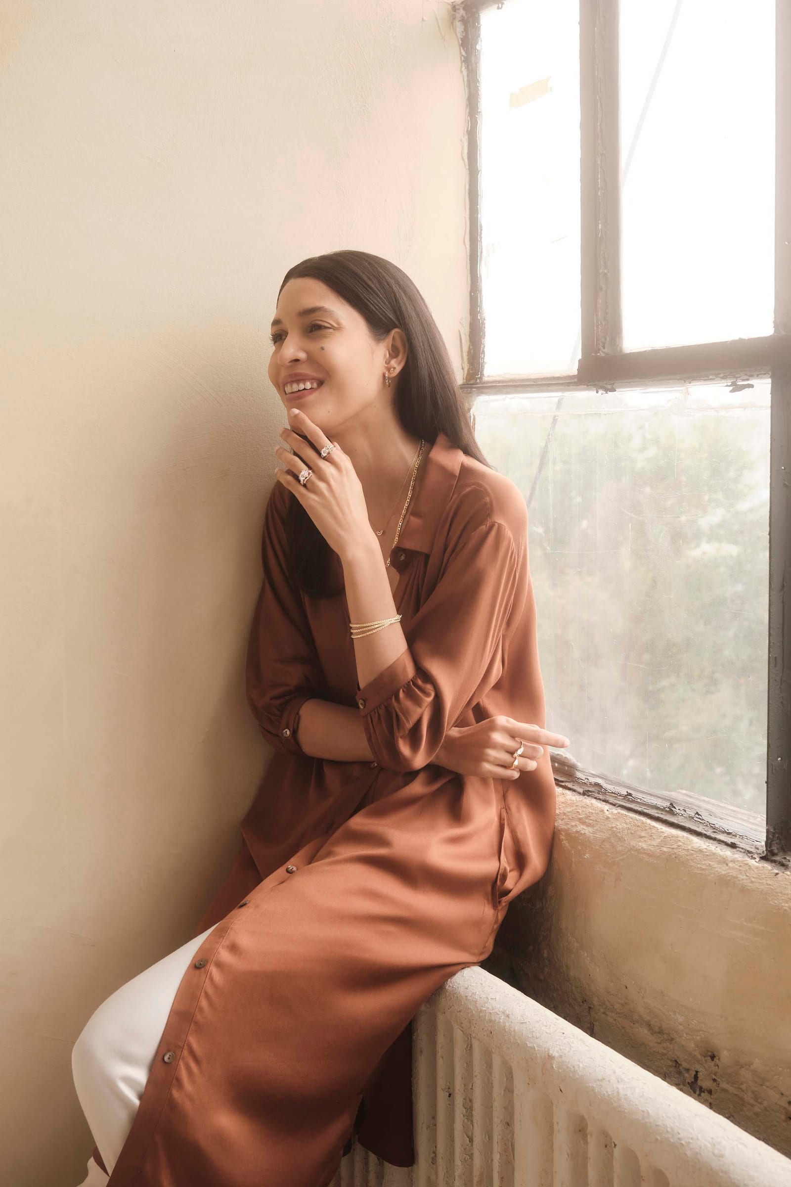 Sitting in a window in rust silk
