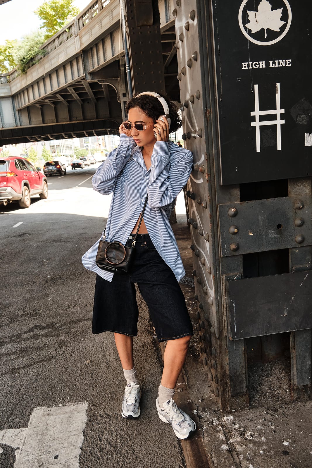 A woman with a camera beside a High Line stairwell