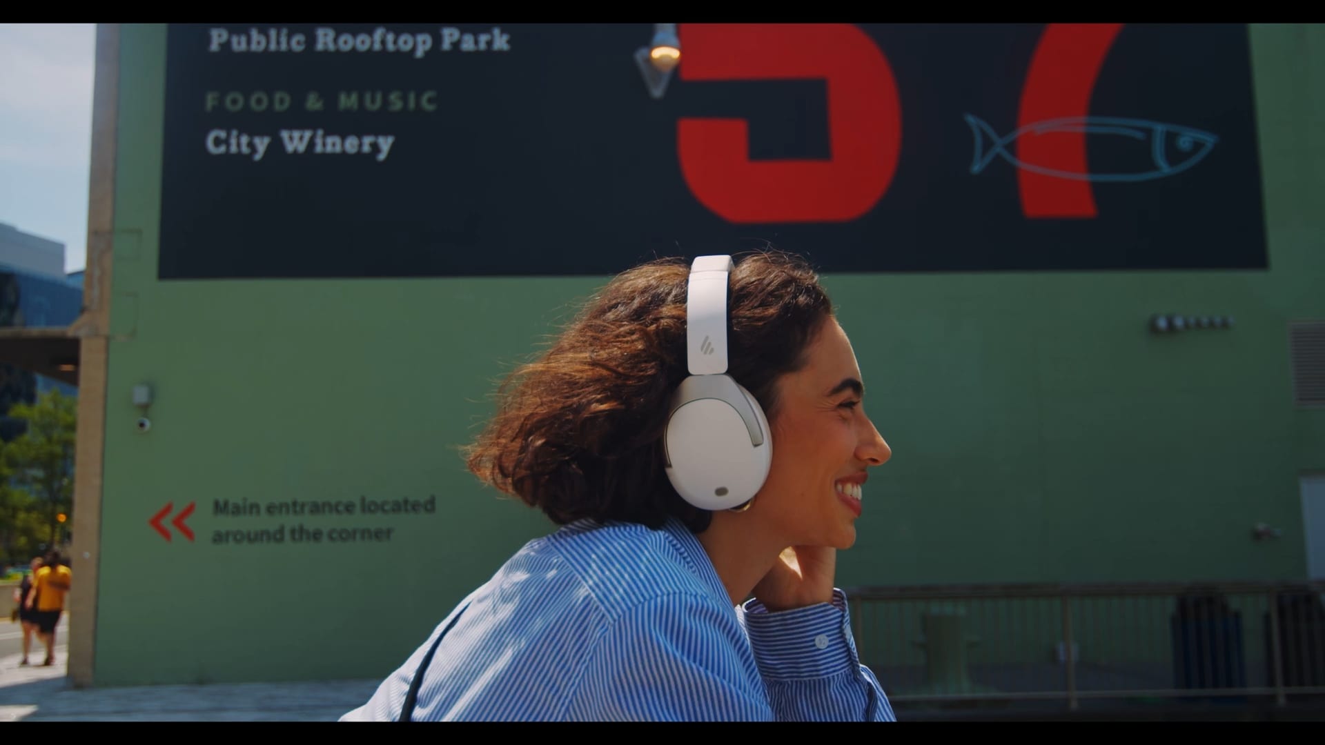 A frame from the brand film, shot past a green hoarding