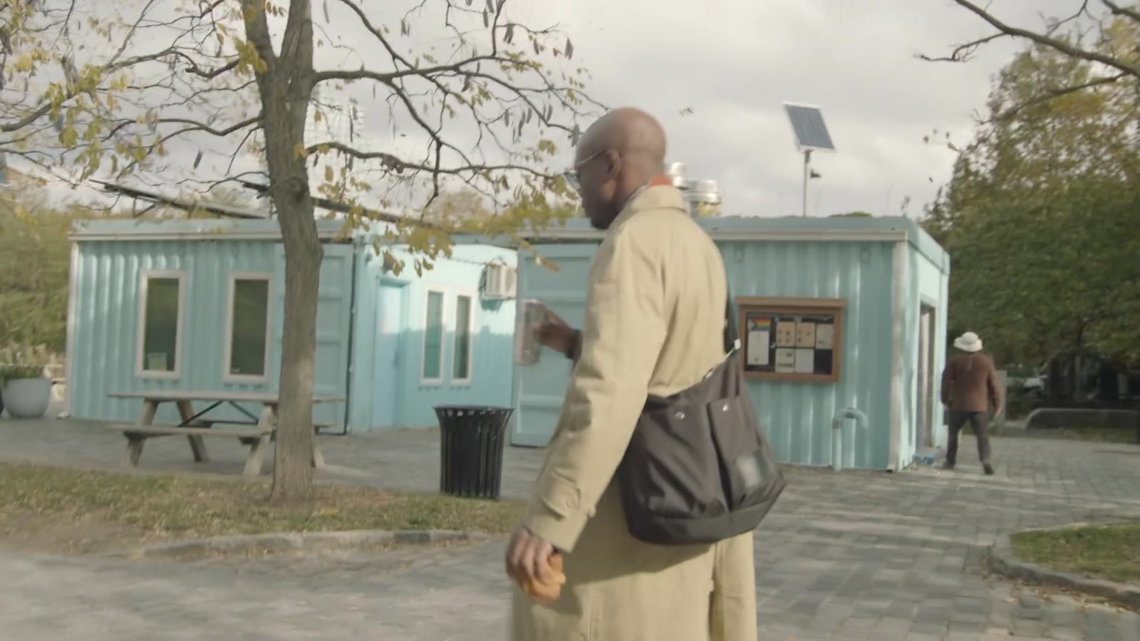 A trench coat walk to the waterfront with the skyline behind