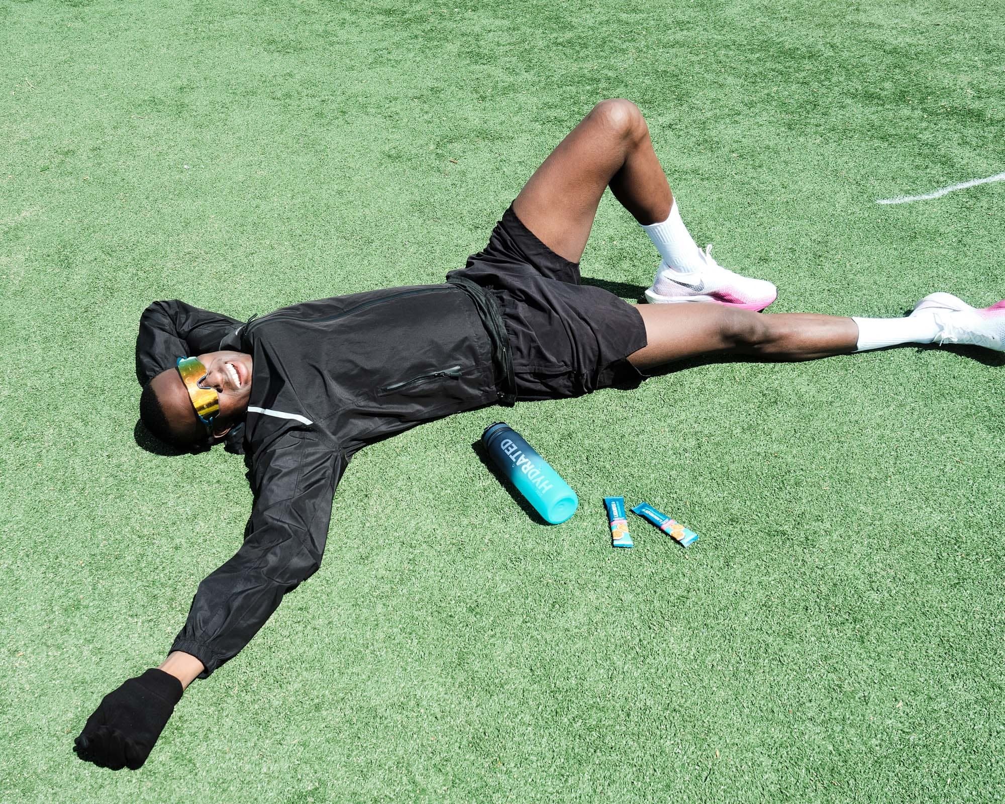 Lying flat on the turf, arms out, done