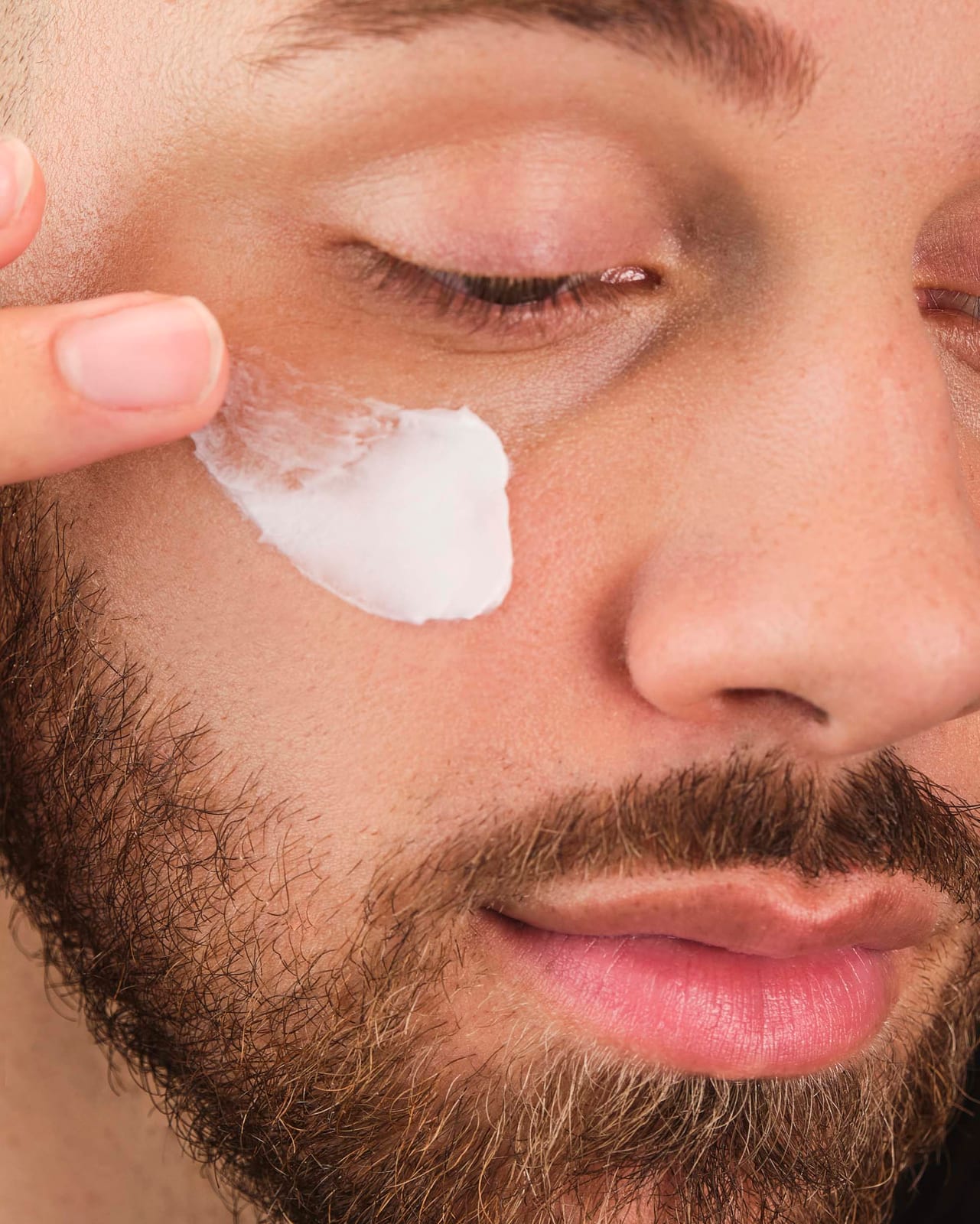 Cream worked into the cheek with two fingers