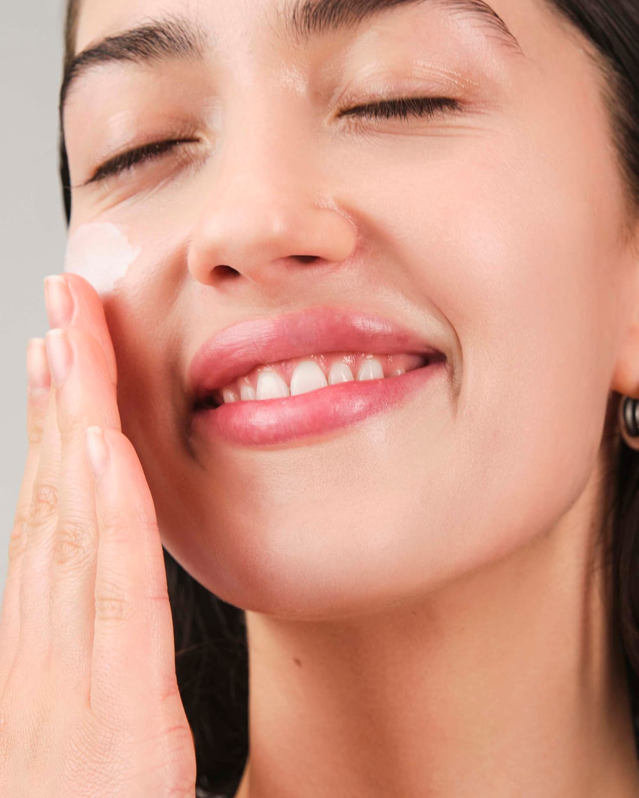A smile with cream still on the hand