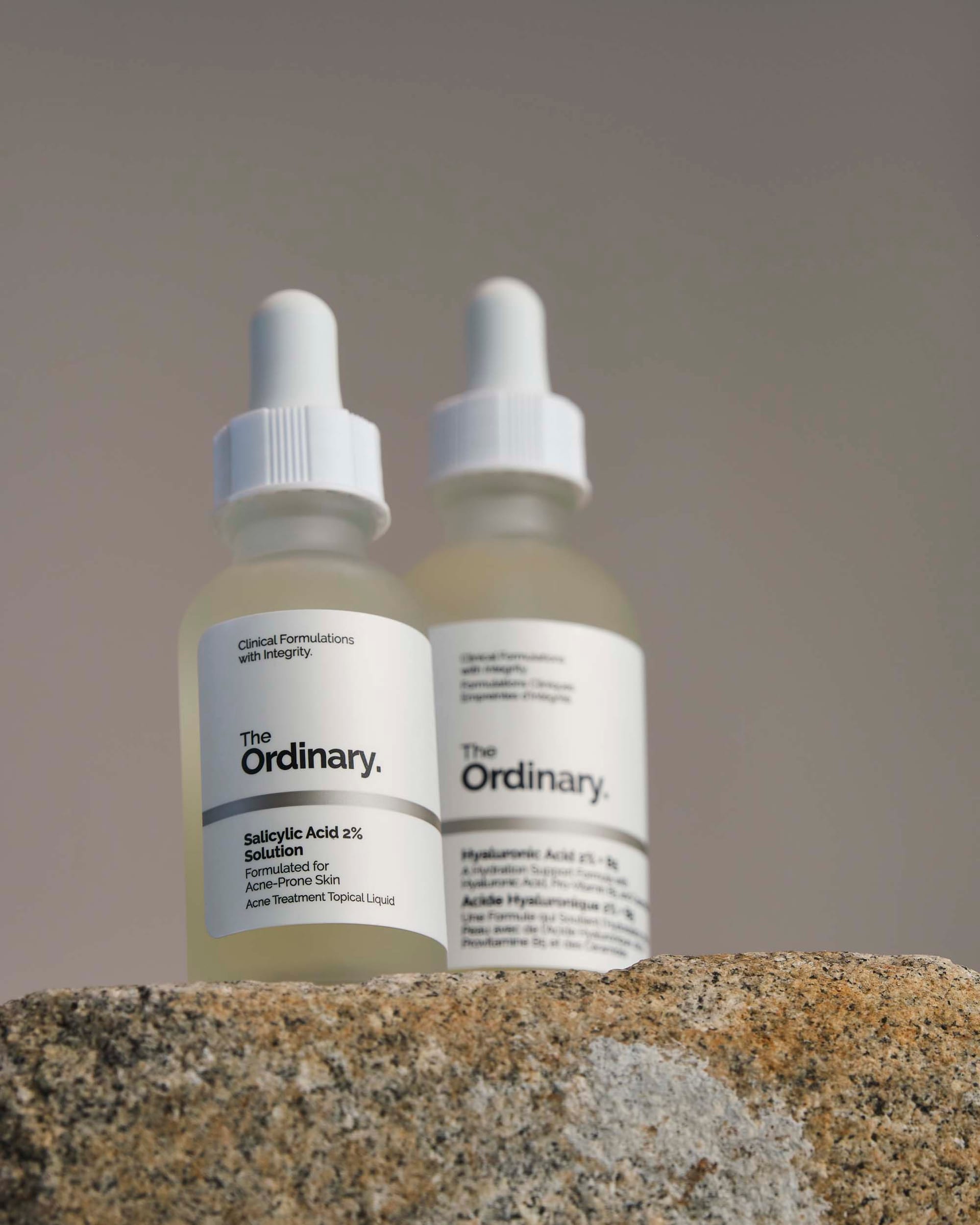 Two bottles standing on rough stone