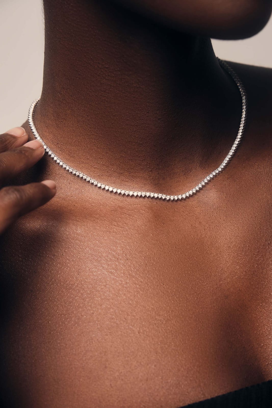 A fine chain necklace across the collarbone